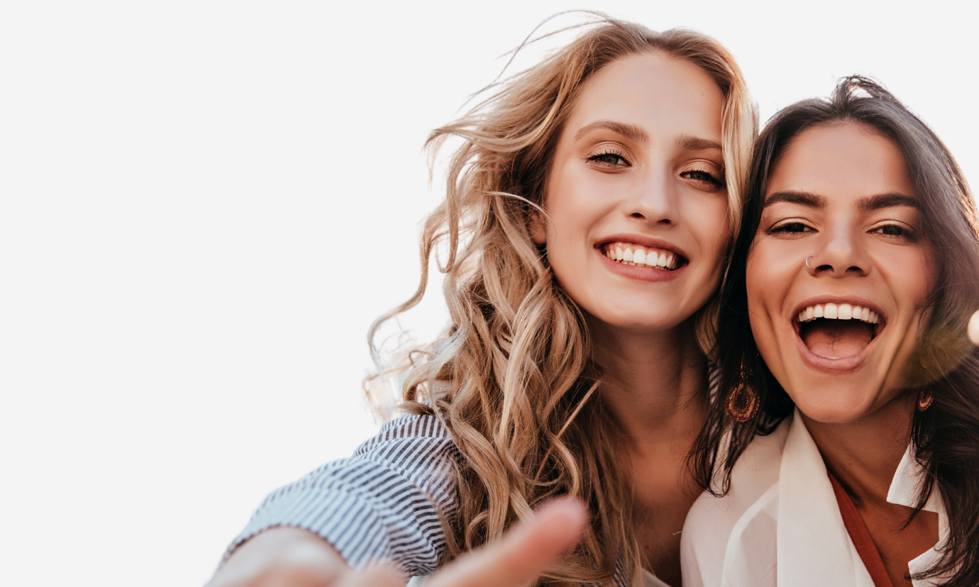 two women smile and laugh together