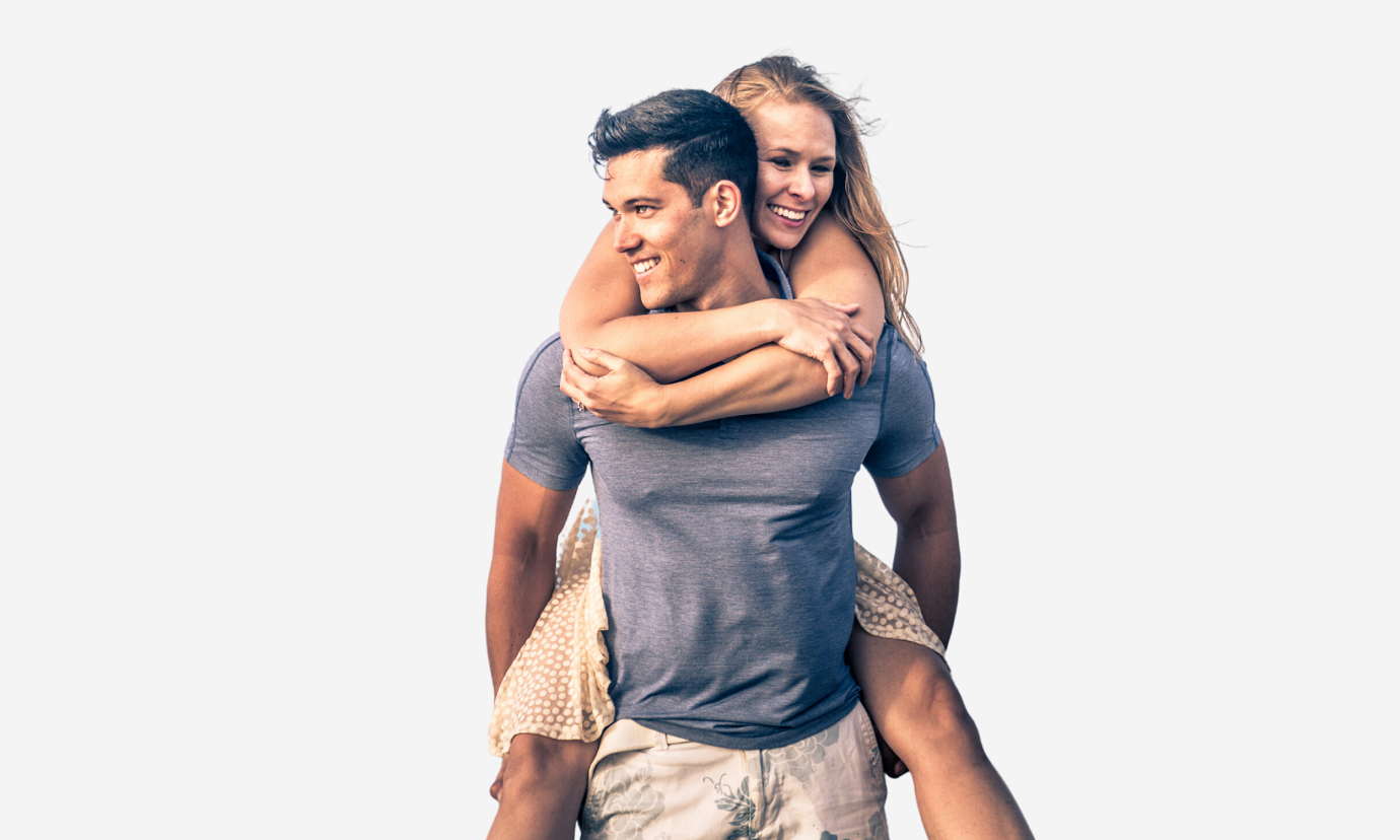 young woman with bright smile piggy backs on her boyfriend