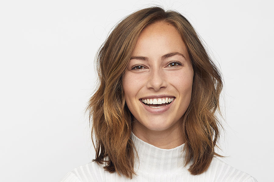 headshot of a woman before her teeth whitening appointment