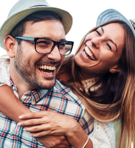 middle aged white couple hug each other with bright smiles