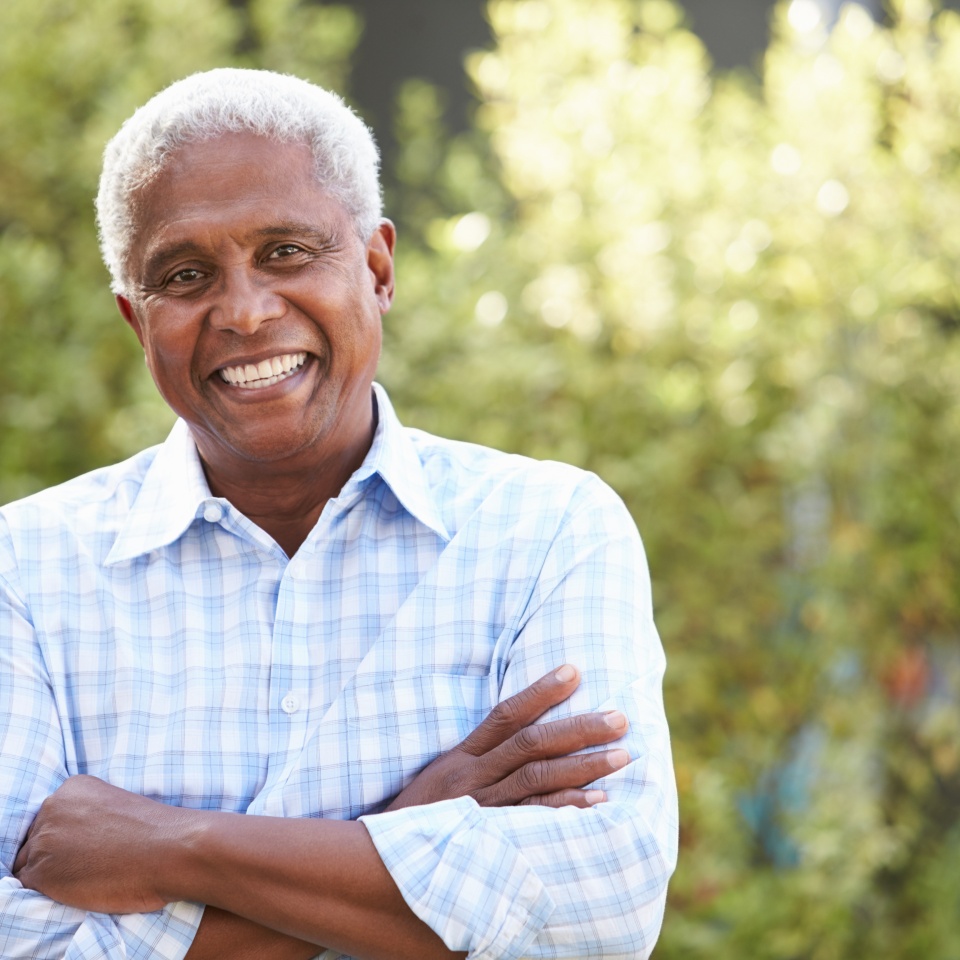 Smiling senior African American man with arms crossed
