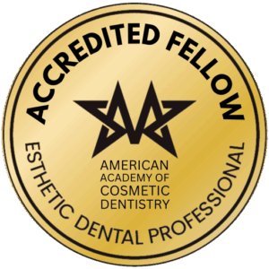 A gold circular seal featuring the text "ACCREDITED FELLOW" and "AMERICAN ACADEMY OF COSMETIC DENTISTRY ESTHETIC DENTAL PROFESSIONAL," with a stylized black star logo in the center.